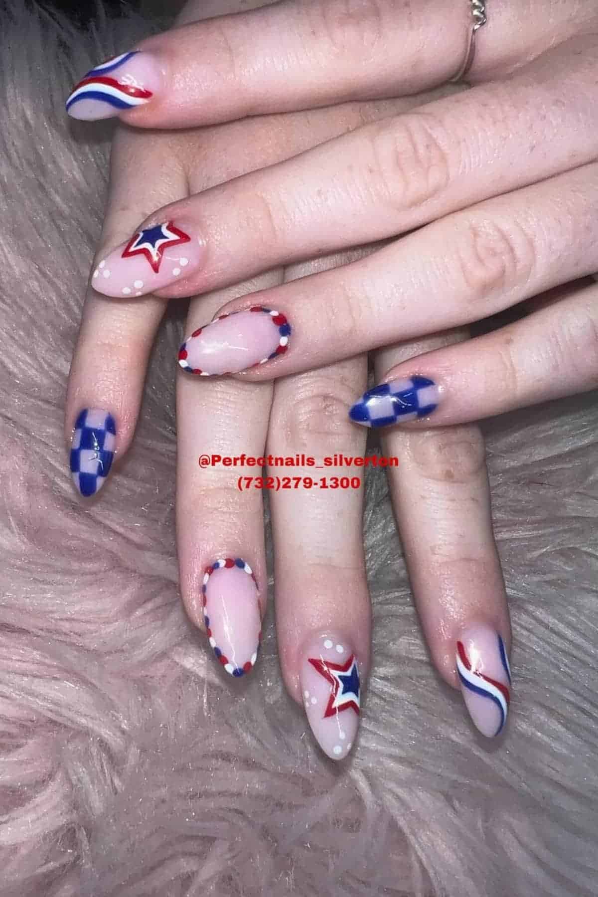 Hands with manicured nails featuring red, white, and blue patriotic designs, including stars, stripes, and dotted accents, resting on a furry surface.