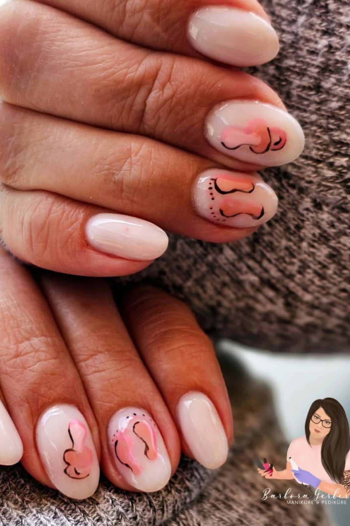 Close-up of hands with light pink manicured nails featuring abstract line art designs in black and pink on two fingernails.