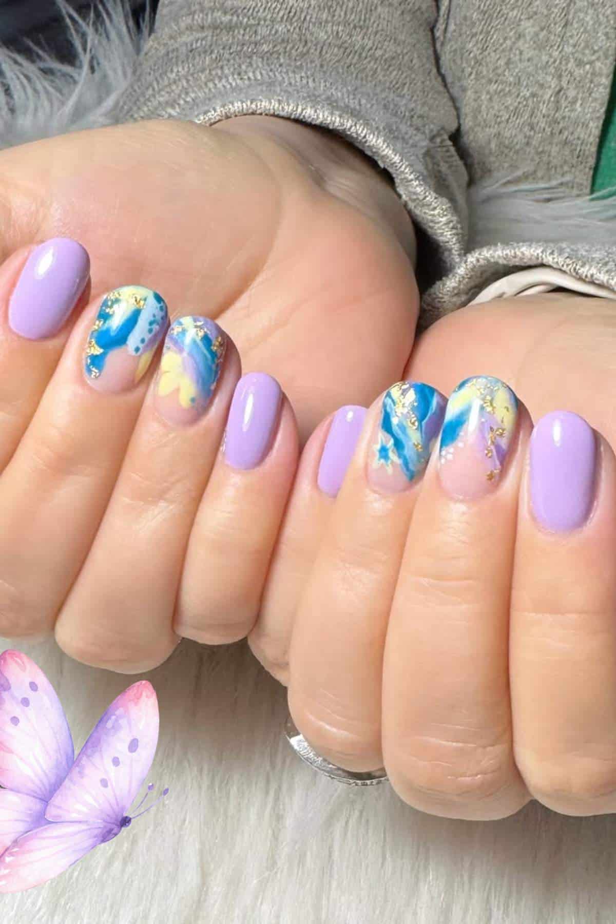 Hands with oval-shaped nails featuring a pastel lavender polish, and accent nails with blue, white, gold, and yellow abstract designs. Part of a butterfly graphic appears in the bottom left corner.