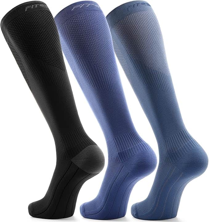 Three knee-high compression socks in black, purple, and blue are displayed upright side by side on a white background.