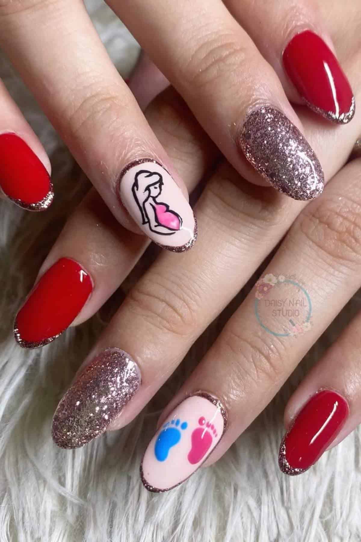 Hands with manicured nails; some nails are painted red, some have glitter, and two feature designs: a pregnant woman and blue and pink baby footprints.