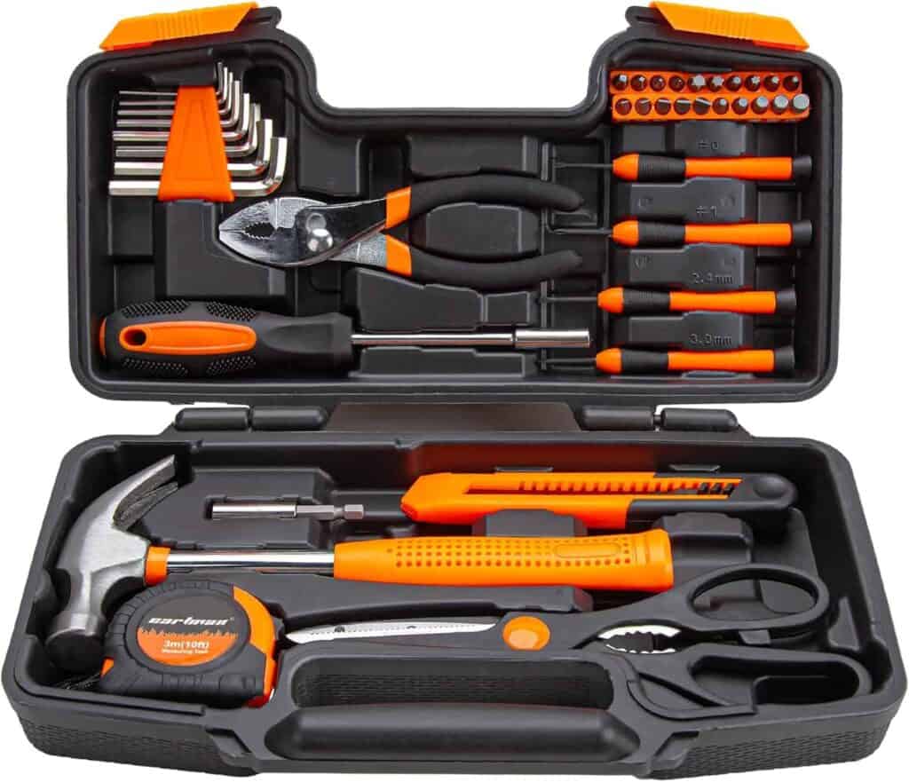 A black and orange tool kit with various hand tools including a hammer, pliers, screwdrivers, a tape measure, utility knife, and hex keys arranged in a plastic case.