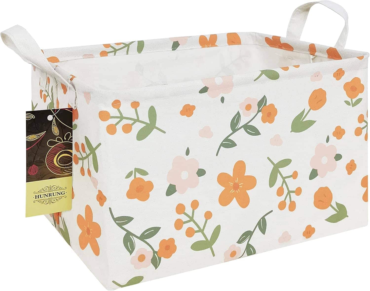 Rectangular fabric storage bin with handles, featuring an orange and green floral pattern on a white background and a tag attached to one handle.