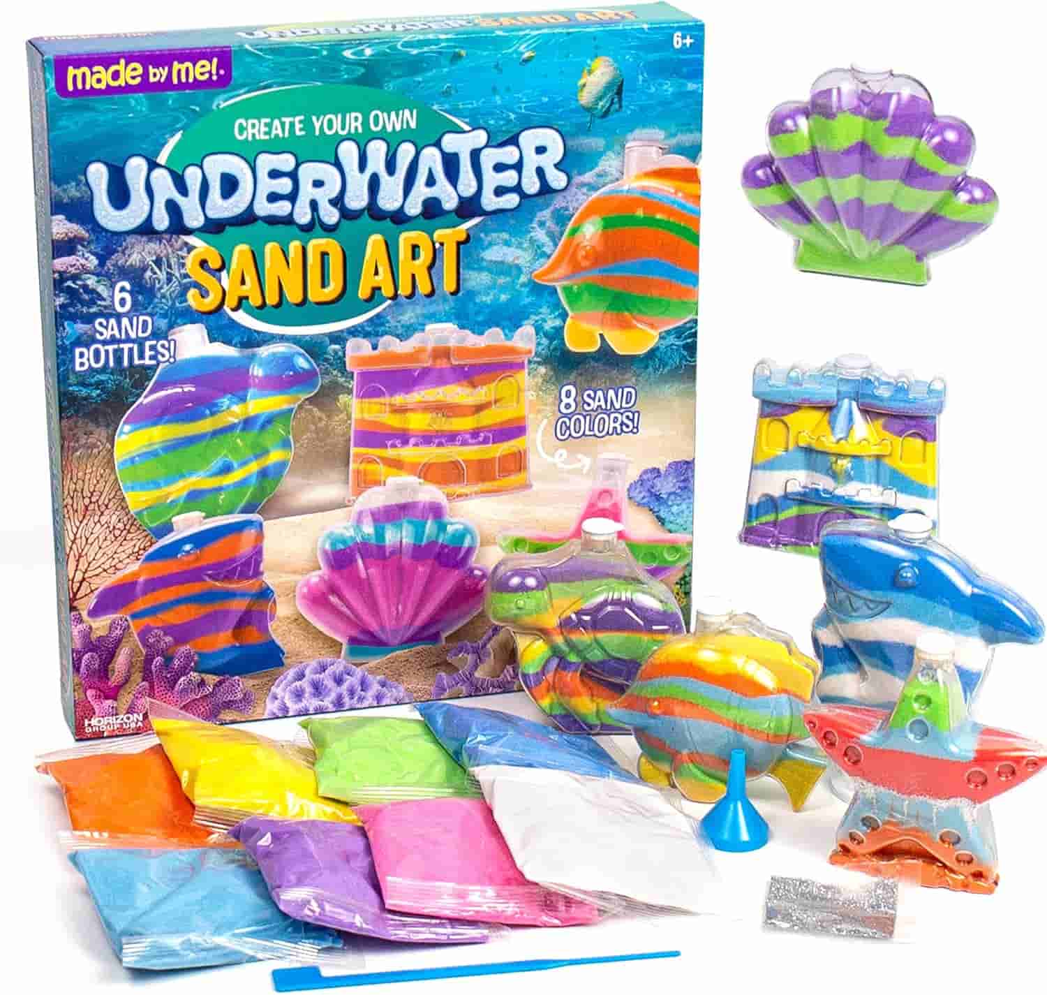 Create Your Own Underwater Sand Art kit with sand bottles in sea shapes, pouches of colored sand, a funnel, and instructions displayed around the packaging.