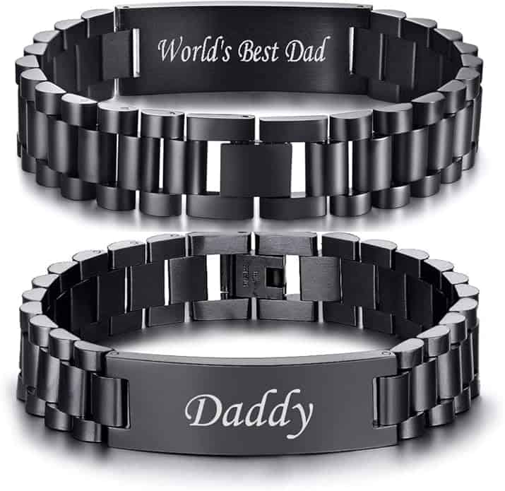 Two black metal link bracelets with engraved messages: one says "World's Best Dad" and the other says "Daddy.