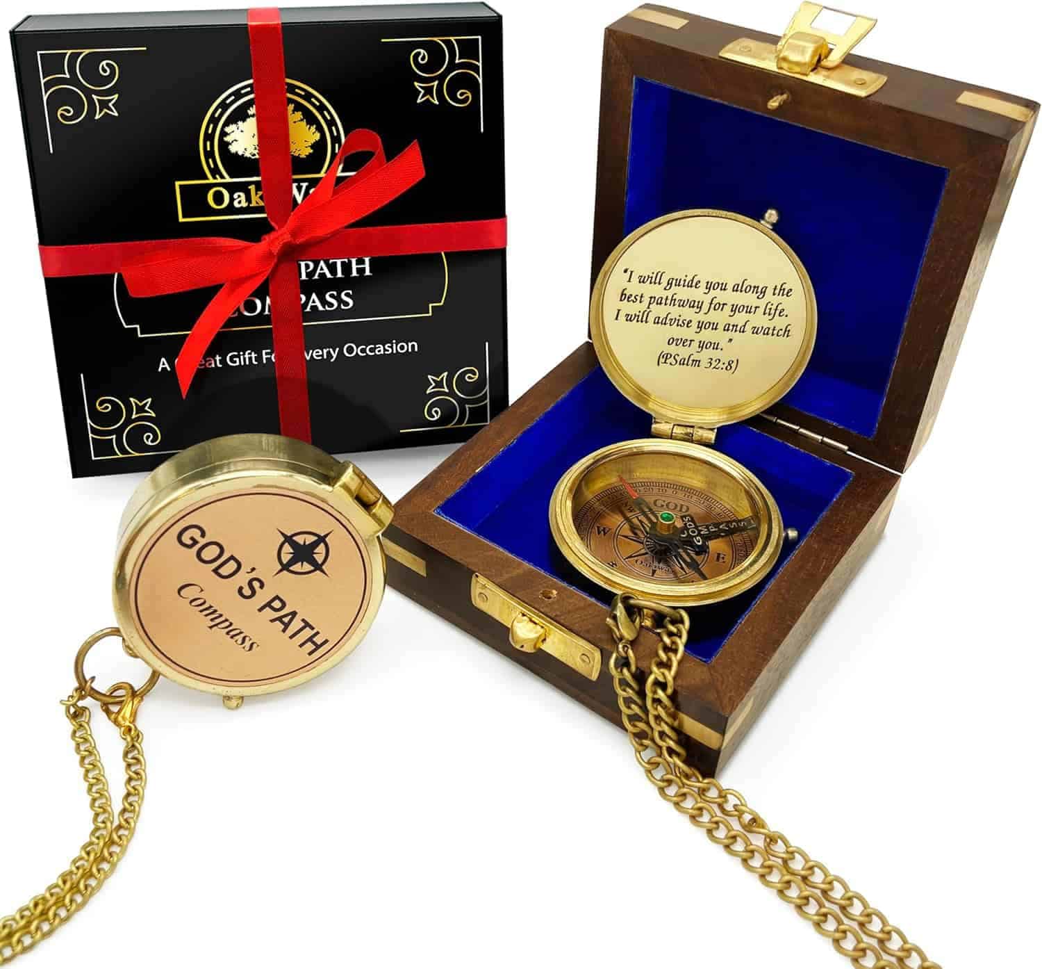 Gift box with a red ribbon, a wooden box with blue lining, and a gold compass engraved with "God's Path Compass" and a Psalm 32:8 quote, including a gold chain.
