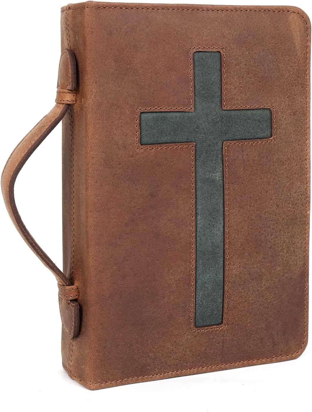 A brown leather book cover with a handle and a large cross design on the front.