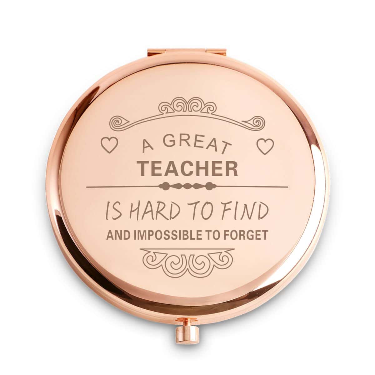 Round rose gold compact mirror with engraved text: "A GREAT TEACHER IS HARD TO FIND AND IMPOSSIBLE TO FORGET," decorated with small hearts and ornate designs.