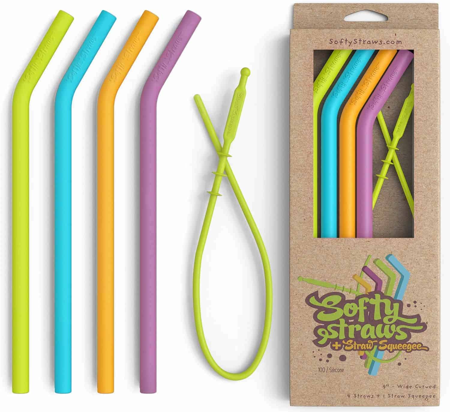 Five colorful silicone straws and a matching cleaning squeegee are displayed beside a cardboard box labeled "Softy Straws + Straw Squeegee.