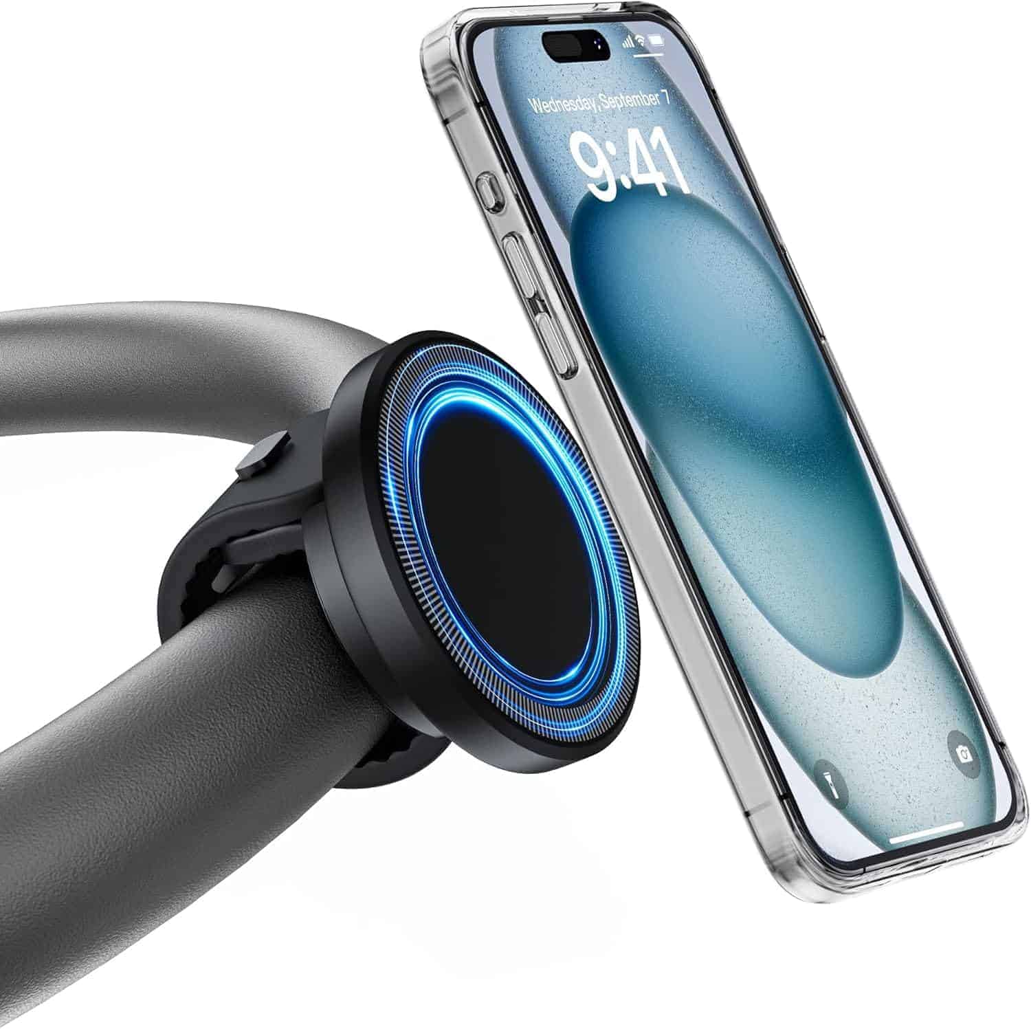 A smartphone is mounted on a car steering wheel using a circular magnetic holder with a blue LED light.