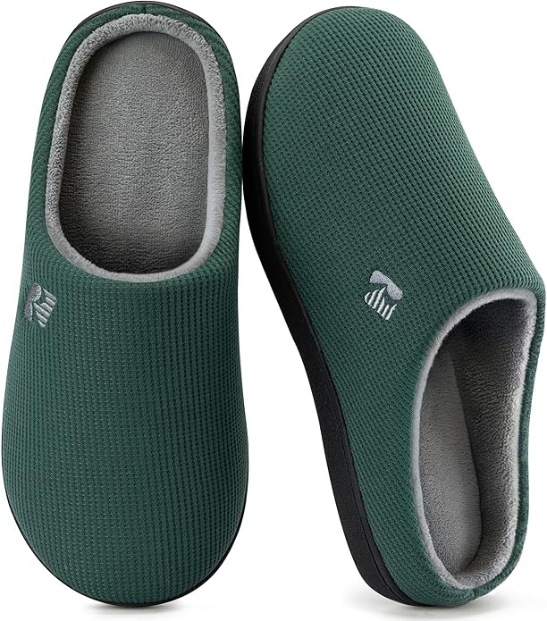 A pair of dark green, closed-toe slippers with a textured fabric exterior, grey inner lining, and black soles, shown from the top and side.