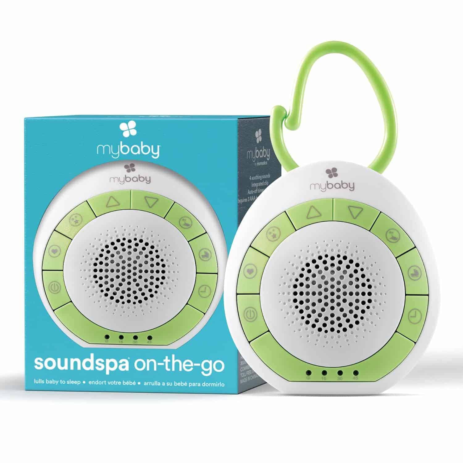 A portable white and green sound machine with buttons and a hook, shown next to its packaging labeled "mybaby soundspa on-the-go.