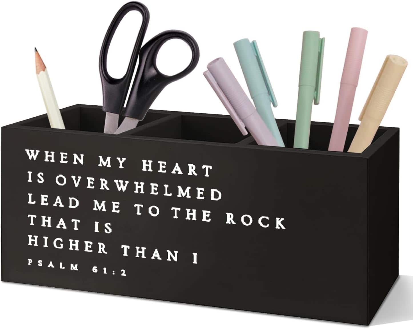 A black desk organizer holds scissors, pens, pencils, and markers. The front displays the text: “When my heart is overwhelmed, lead me to the rock that is higher than I. Psalm 61:2.”.