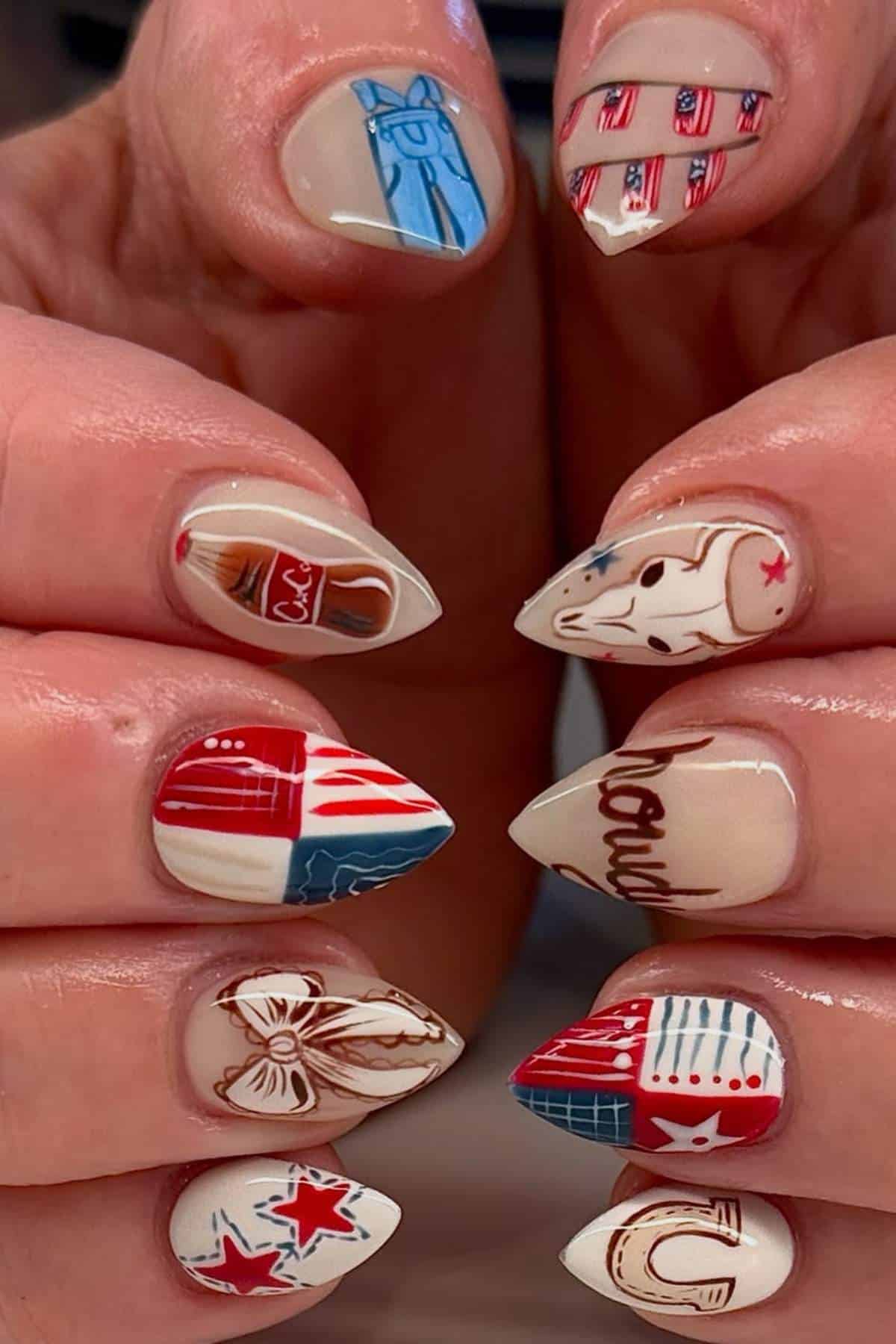 Close-up of hands with pointed nails featuring rodeo-themed nail art, including cowboy boots, hats, bandanas, stars, and western patterns in red, white, blue, and beige tones.