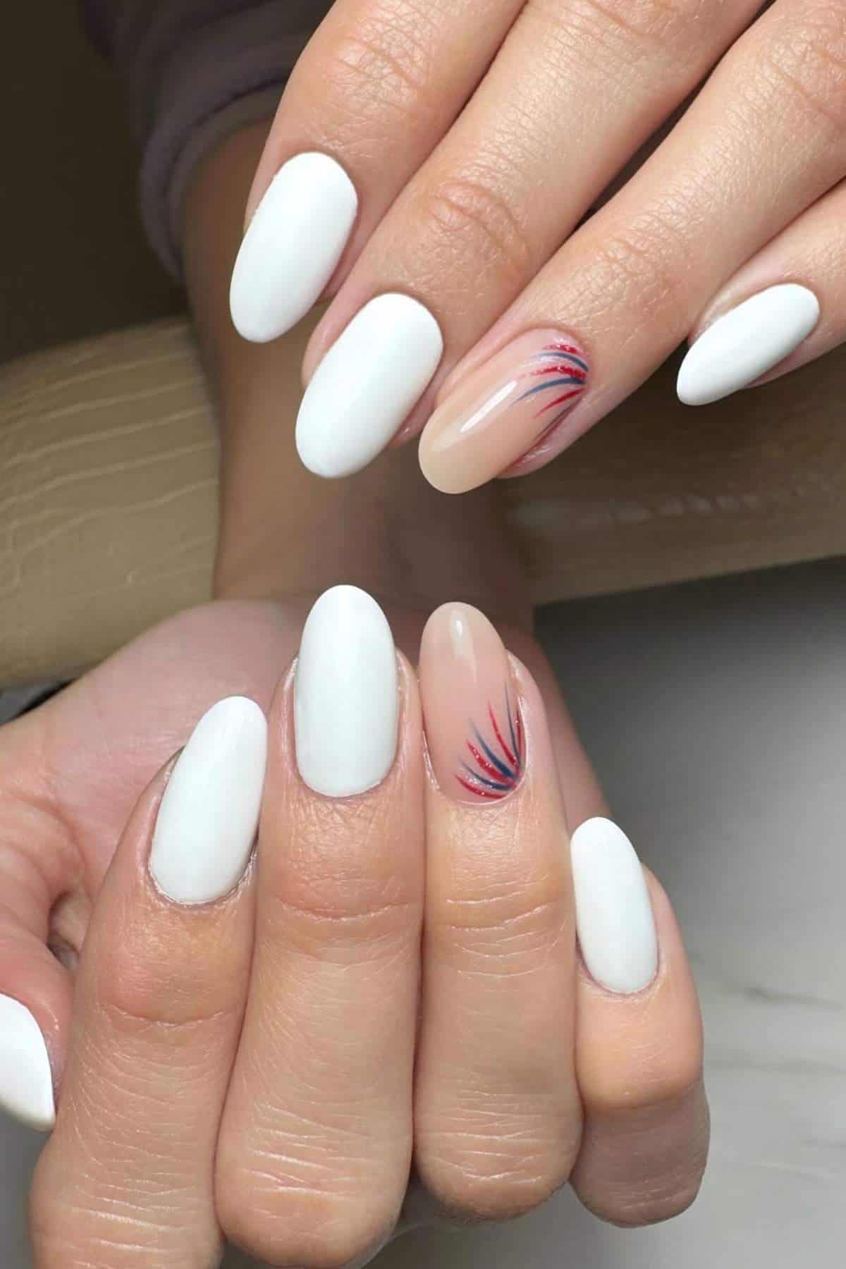 Ovals nails with white polish, with accent nails in nude with red and blue line art.