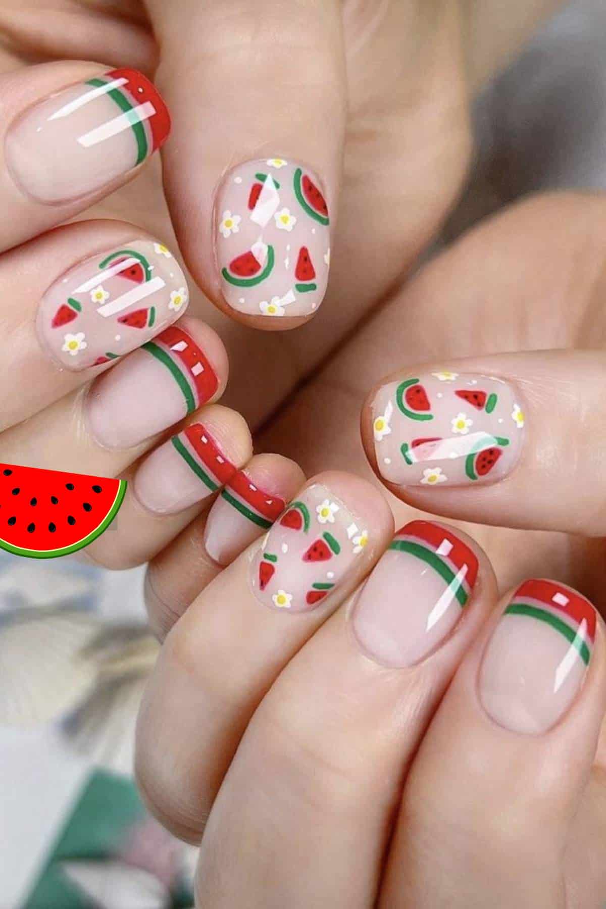 Close-up of fingernails painted with watermelon-themed nail art, featuring red, green, and white tips, plus small watermelon slice and flower designs.