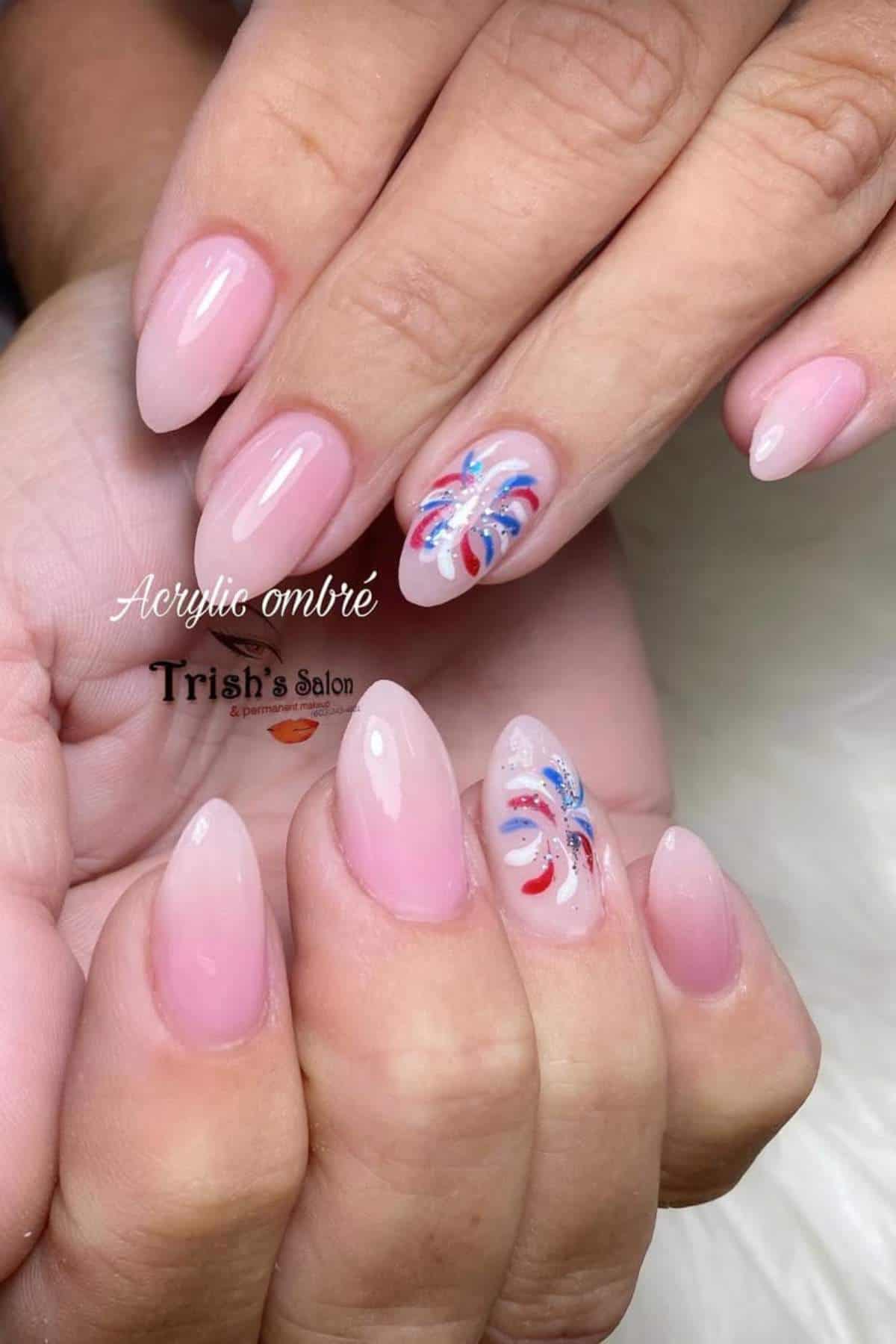 Acrylic ombré nails with red, white, and blue firework designs.