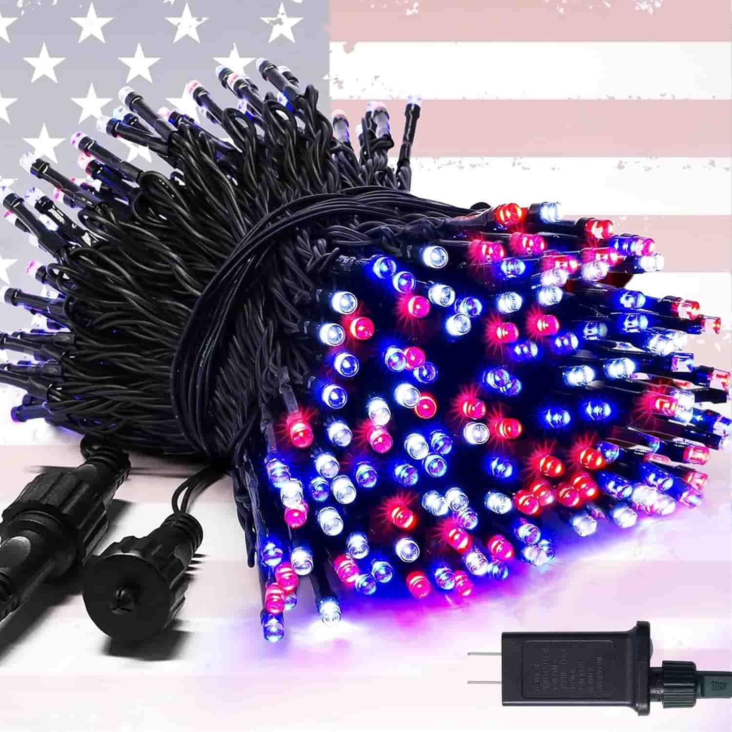 A bundle of red, white, and blue LED string lights with a power adapter, set against a faded American flag background.
