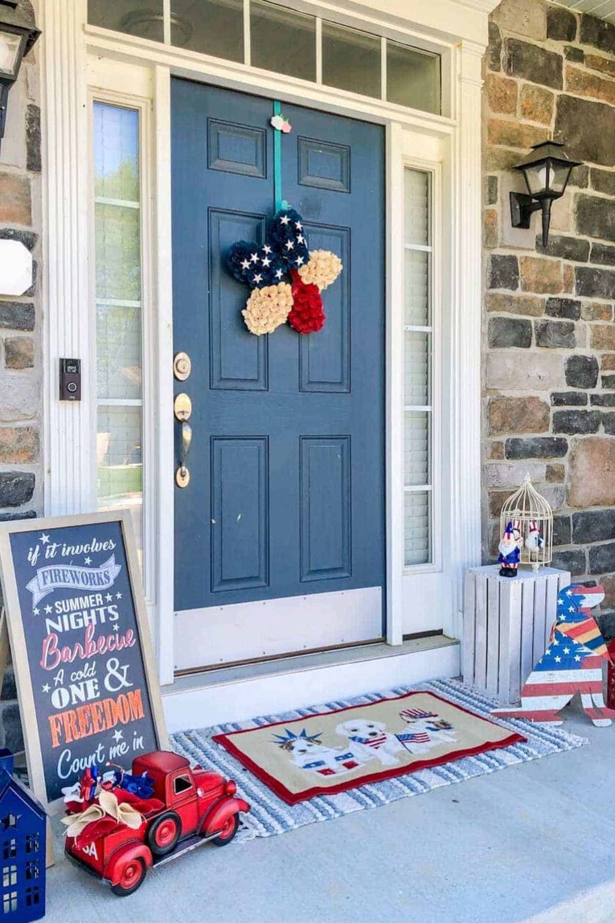 Front door decorated with a star-shaped wreath and patriotic porch decor.