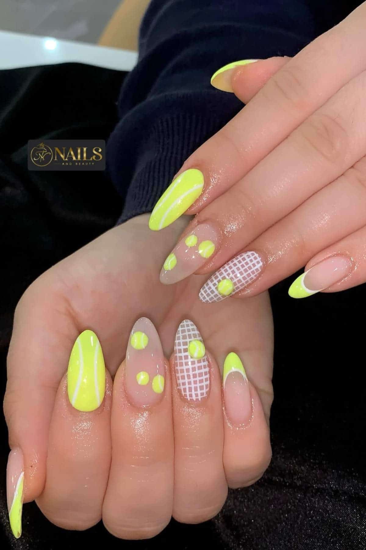 Hands with long, almond-shaped nails featuring neon yellow designs, including French tips, dots, a grid pattern, and a tennis ball motif.