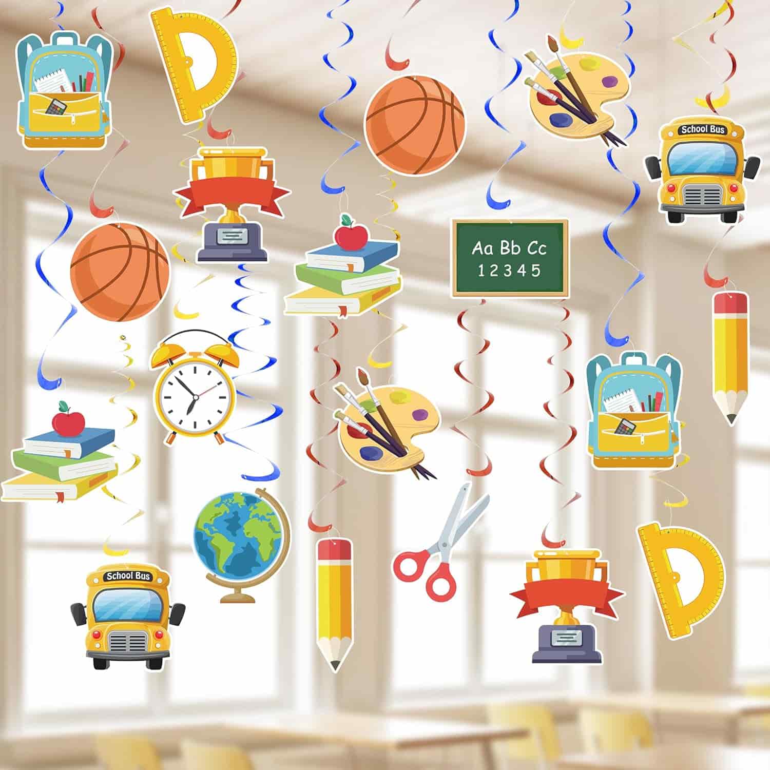 Classroom decorations featuring school buses, books, pencils, scissors, clocks, globes, art palettes, trophies, and ruled boards hanging from colorful swirl ribbons.