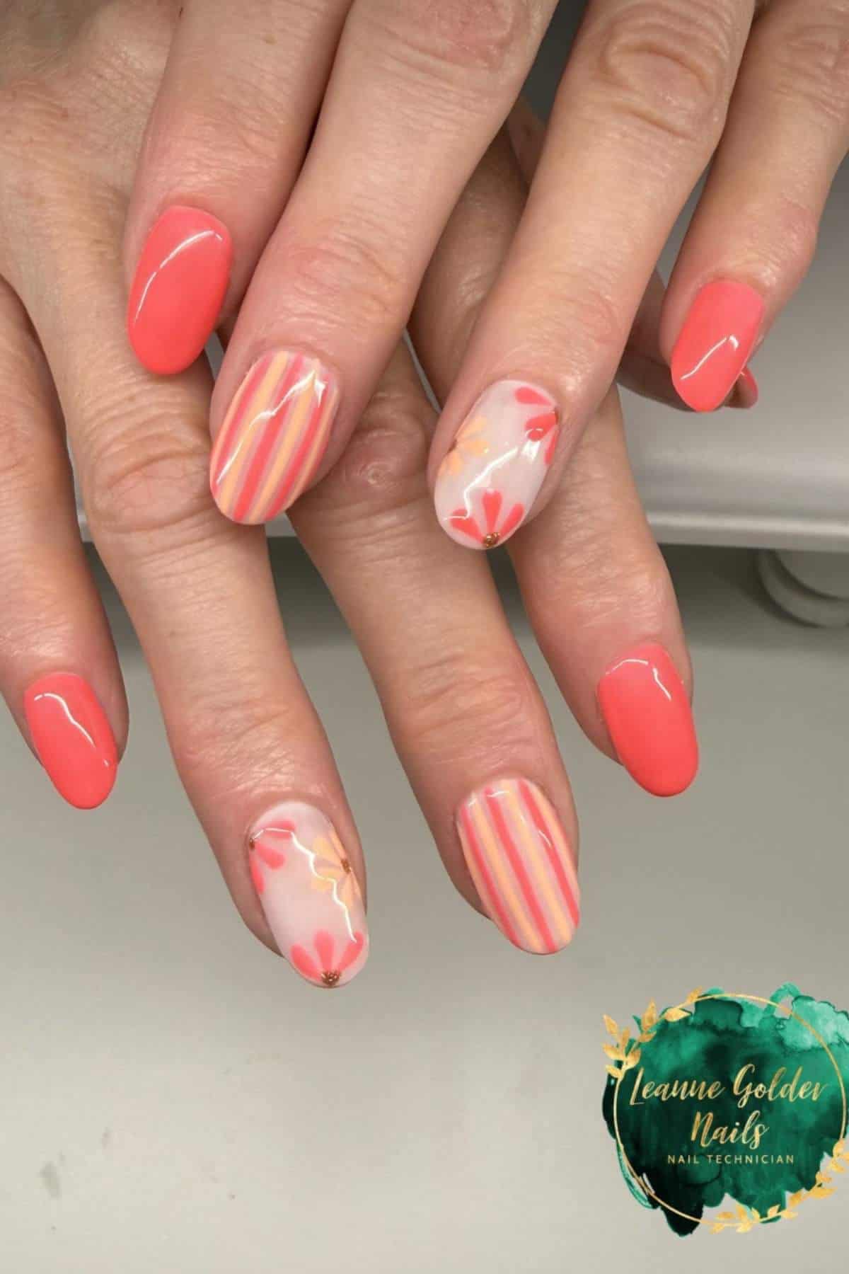 Hands with oval-shaped nails featuring coral polish, floral designs, and pink-yellow striped accents. “Leanne Golden Nails Nail Technician” logo in the lower right corner.