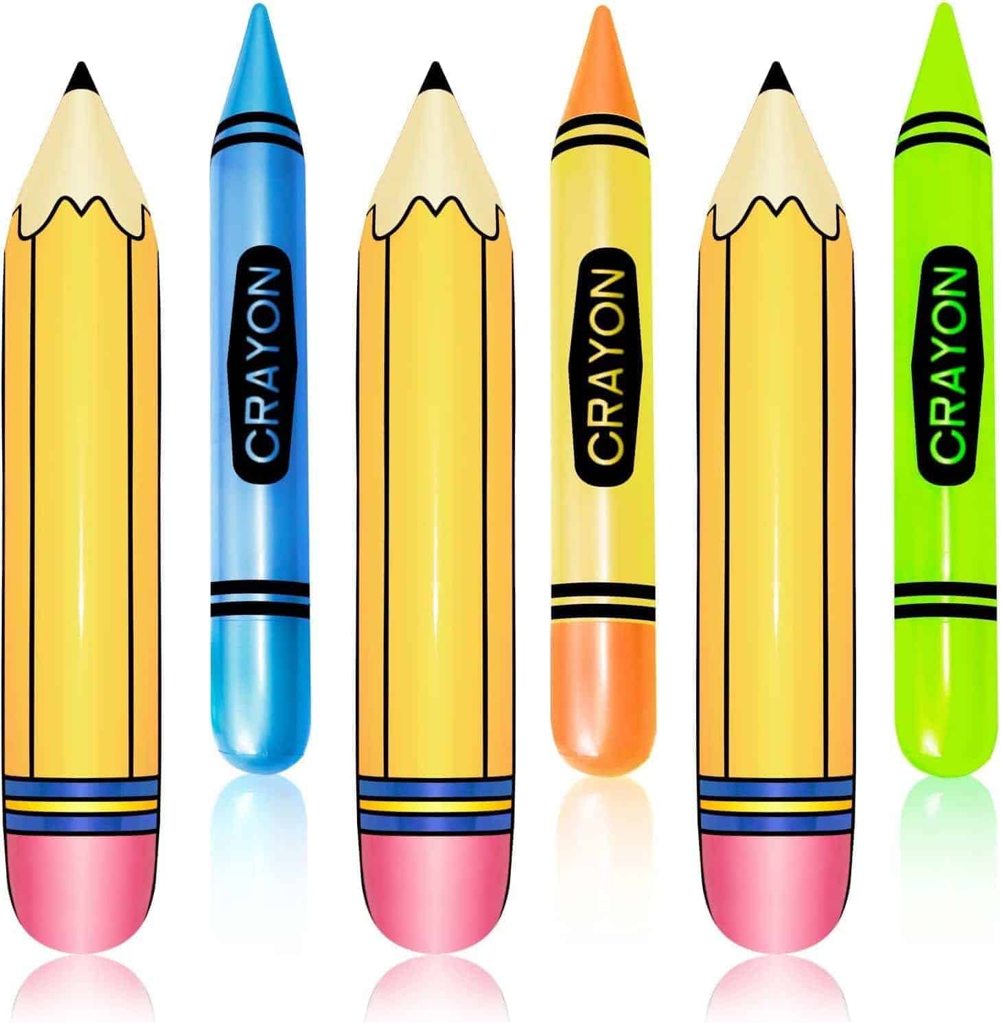 Six inflatable objects shaped like pencils and crayons, in yellow, blue, orange, and green colors, standing upright on a white background.