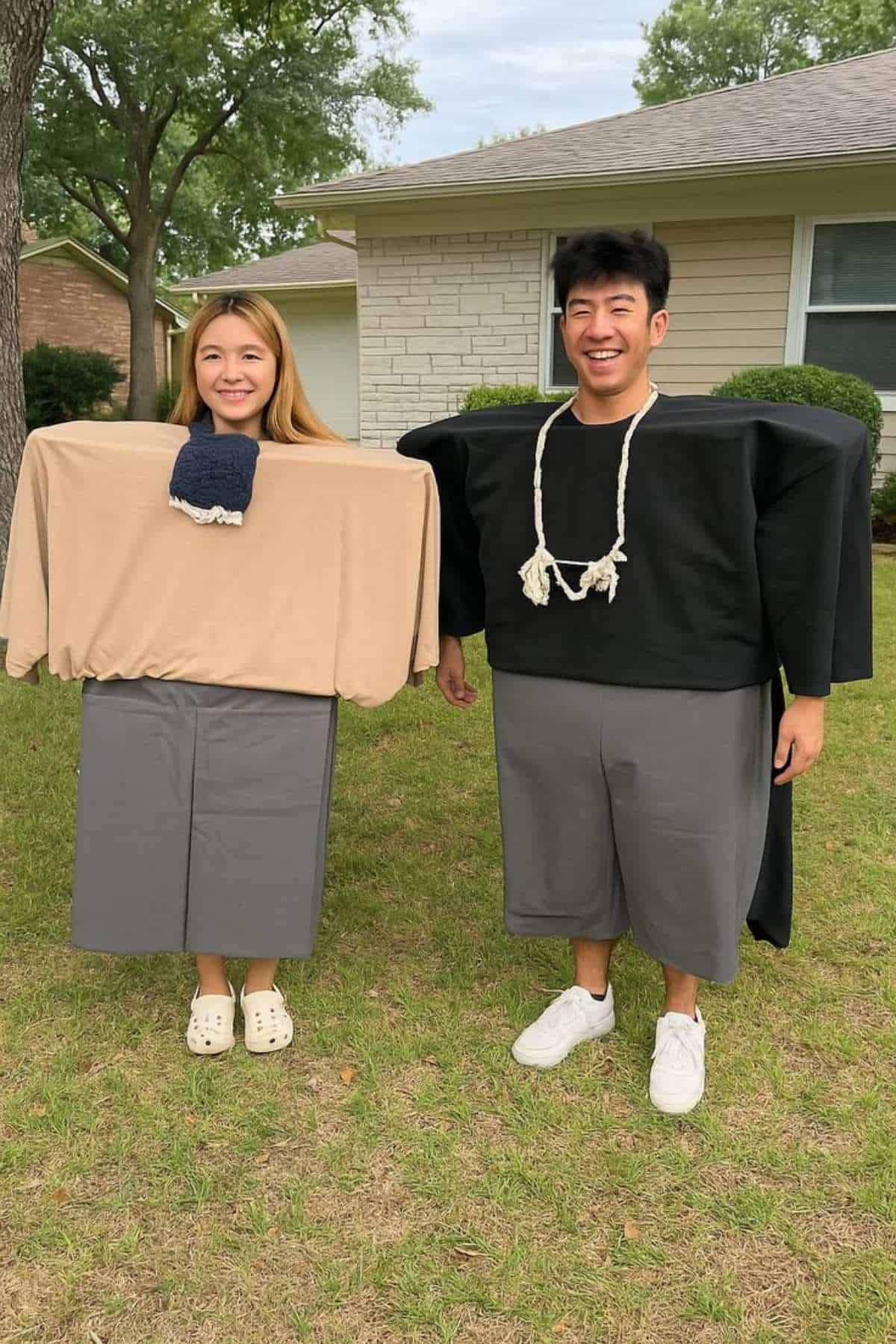 Two people standing outside wearing costumes that make them look like characters with square torsos and blocky limbs, resembling characters from Minecraft.