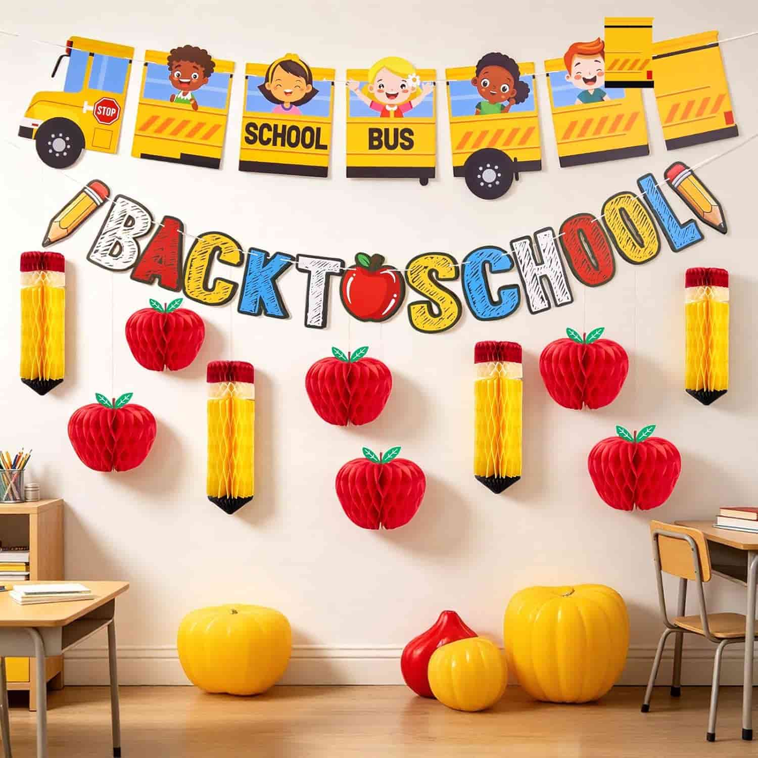 Classroom decorated with "Back to School" banner, red apples, yellow pencils, and a school bus garland above desks and chairs.