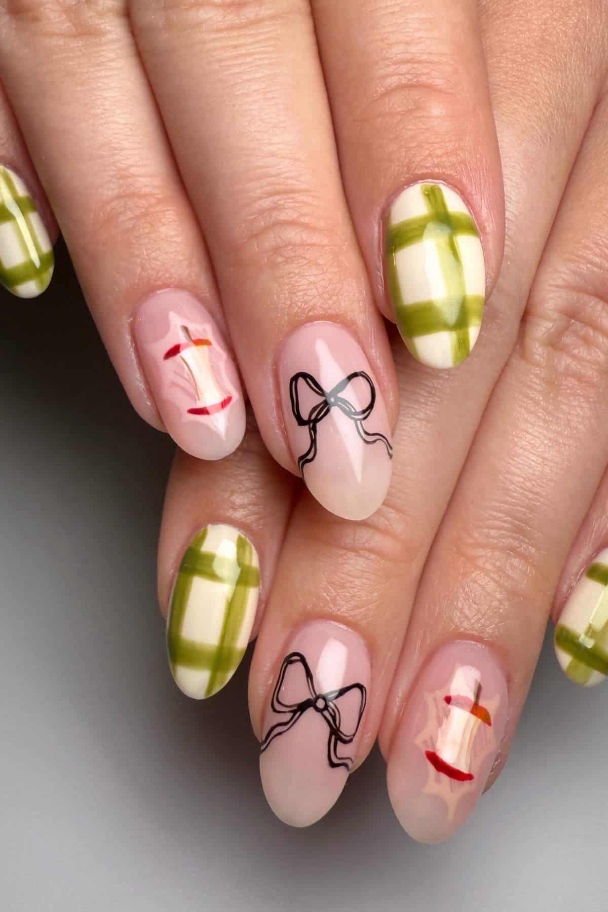 A hand with manicured nails featuring green plaid patterns and minimalist black bows, accented with small red and yellow lines on a nude base.