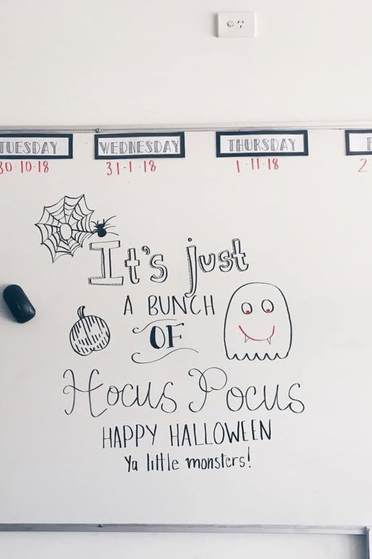 Whiteboard with Halloween drawings and the message: “It’s just a bunch of Hocus Pocus. Happy Halloween ya little monsters!” Dates are written above on the board.