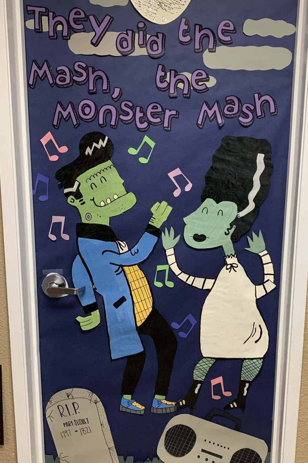 A decorated door features cartoon monsters dancing with colorful musical notes, a tombstone, and a boombox. The text reads, “They did the mash, the monster mash.”.