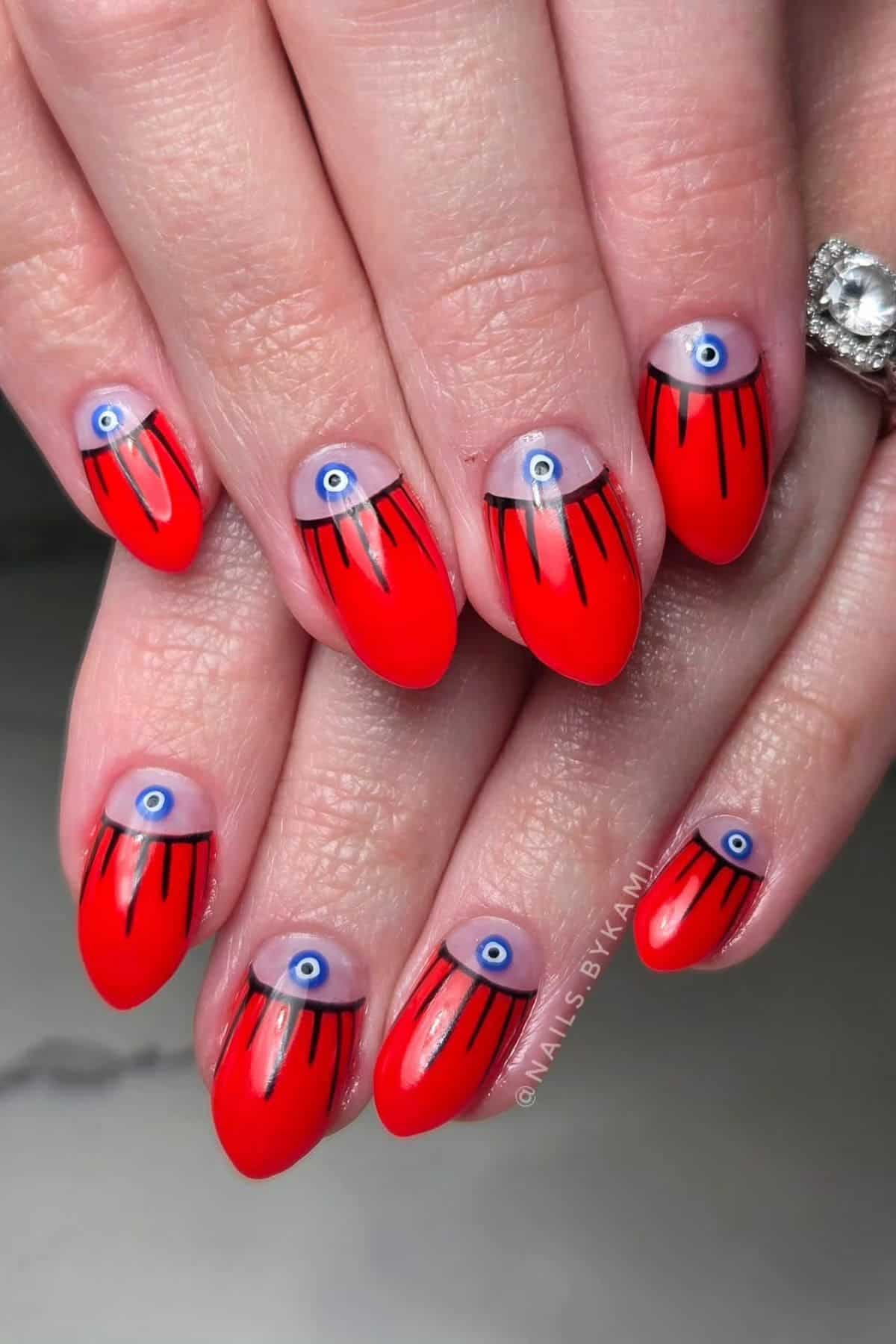 Hands with red almond-shaped nails featuring blue evil eye designs and black lines extending from the cuticle area.