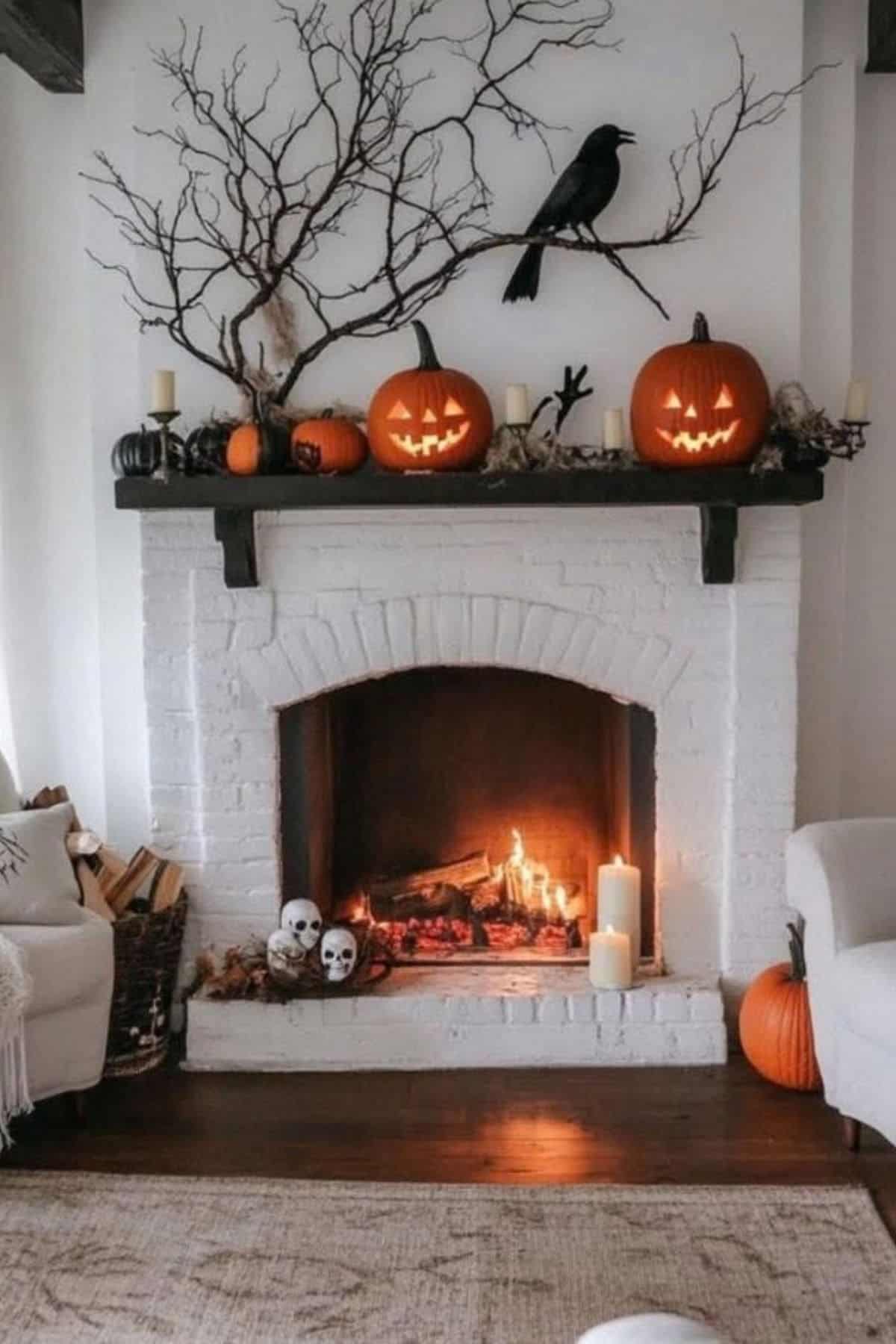 White brick fireplace decorated with carved pumpkins, candles, skull props, branches, and a black crow, creating a Halloween-themed setting. Fire is burning inside the fireplace.
