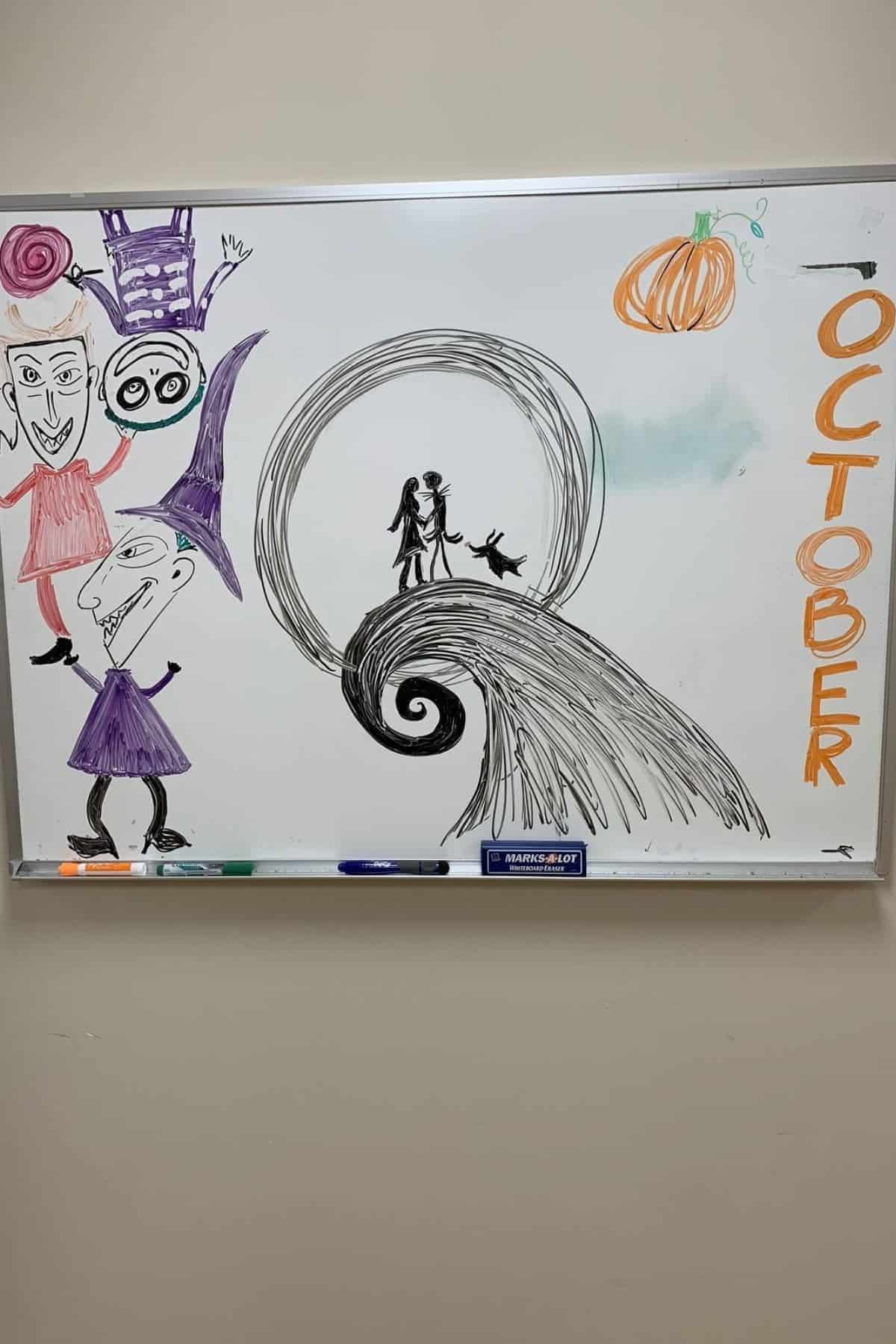 Whiteboard drawing features characters from “The Nightmare Before Christmas,” a pumpkin, and the word “OCTOBER” written vertically in orange letters on the right side.