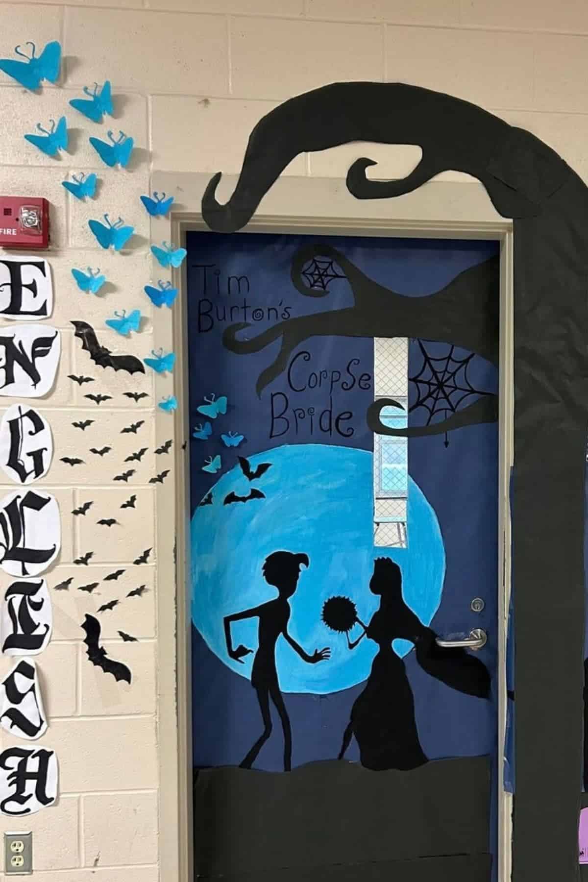 Classroom door decorated with a “Corpse Bride” theme, showing silhouettes, blue moon, bats, spiders, web, butterflies, and “ENGLISH” sign on the left wall.